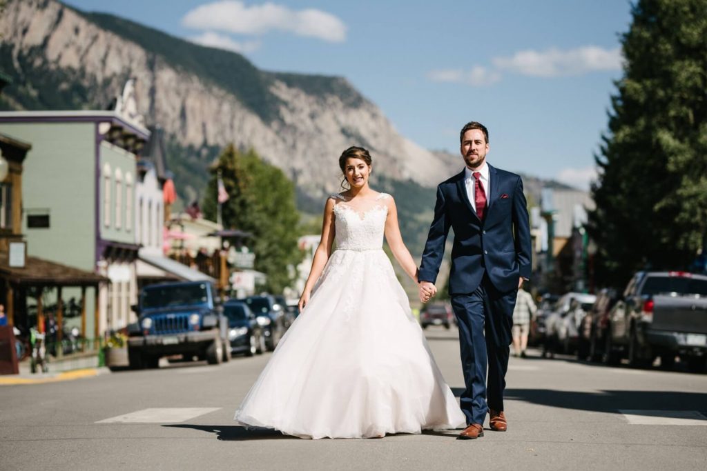 bride and groom walking in the town of Crested Butte, Colorado on their wedding day