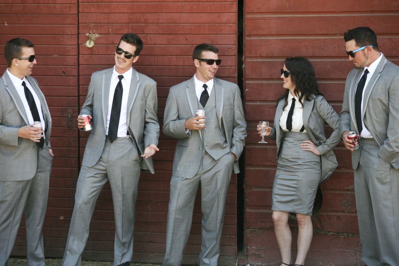 four guys in grey suits and one lady in grey skirt and jacket