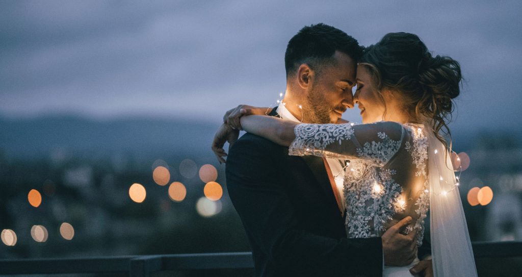 couple with lights in embrace