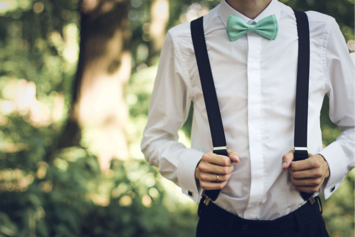 Guy wearing suspenders with mint green bow tie