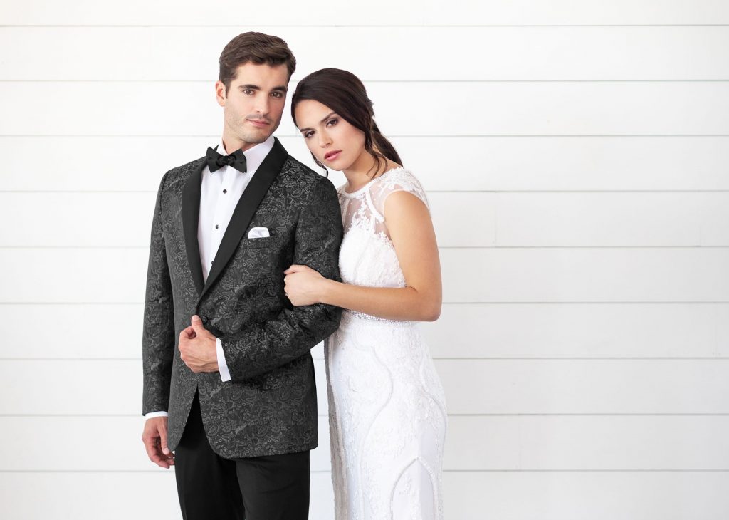 Picking a Tux: Groom in a stylish wedding tux with his bride