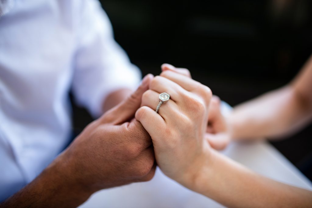 How to Pick out an Engagement Ring - Couple holding hands