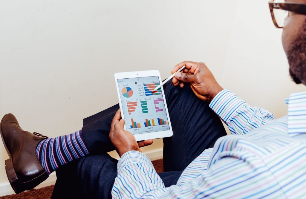 When to wear a suit to an interview - Man in business casual attire on an ipad