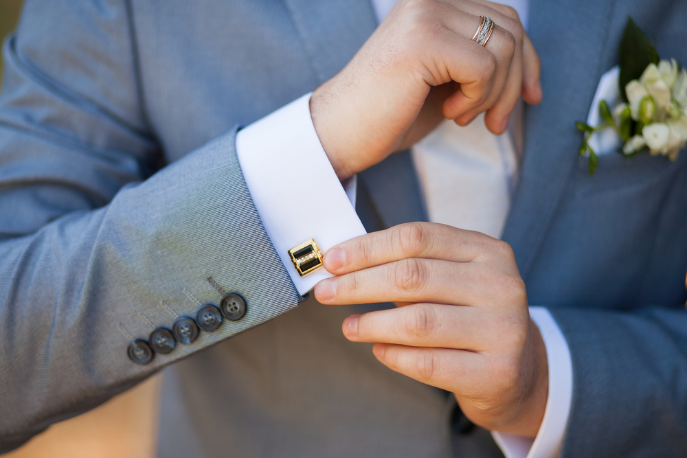 How to Pick the right cufflinks - Man in gray tuxedo adjusting cufflink