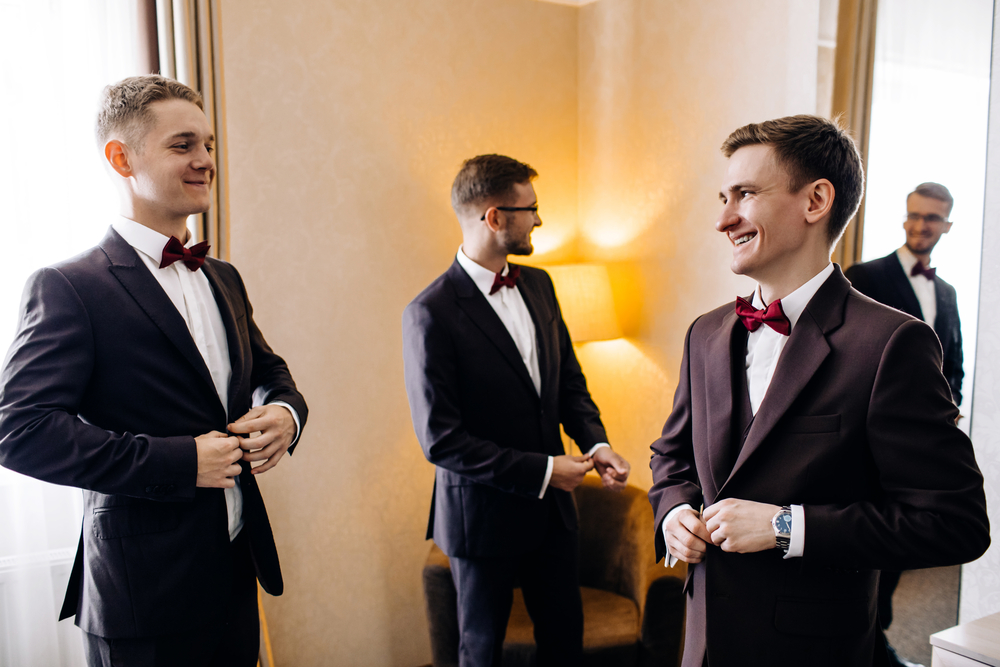 How to pick your groomsmen -Three male friends meet and speaking to each other. Grooms