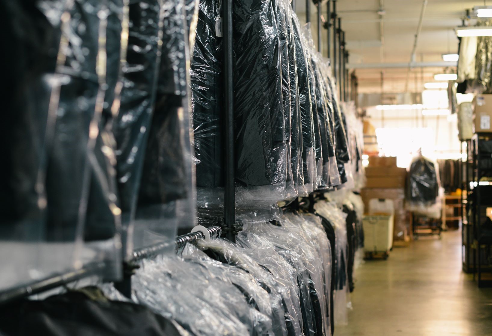 How to clean a suit without dry cleaning - Suits in bags on a rack