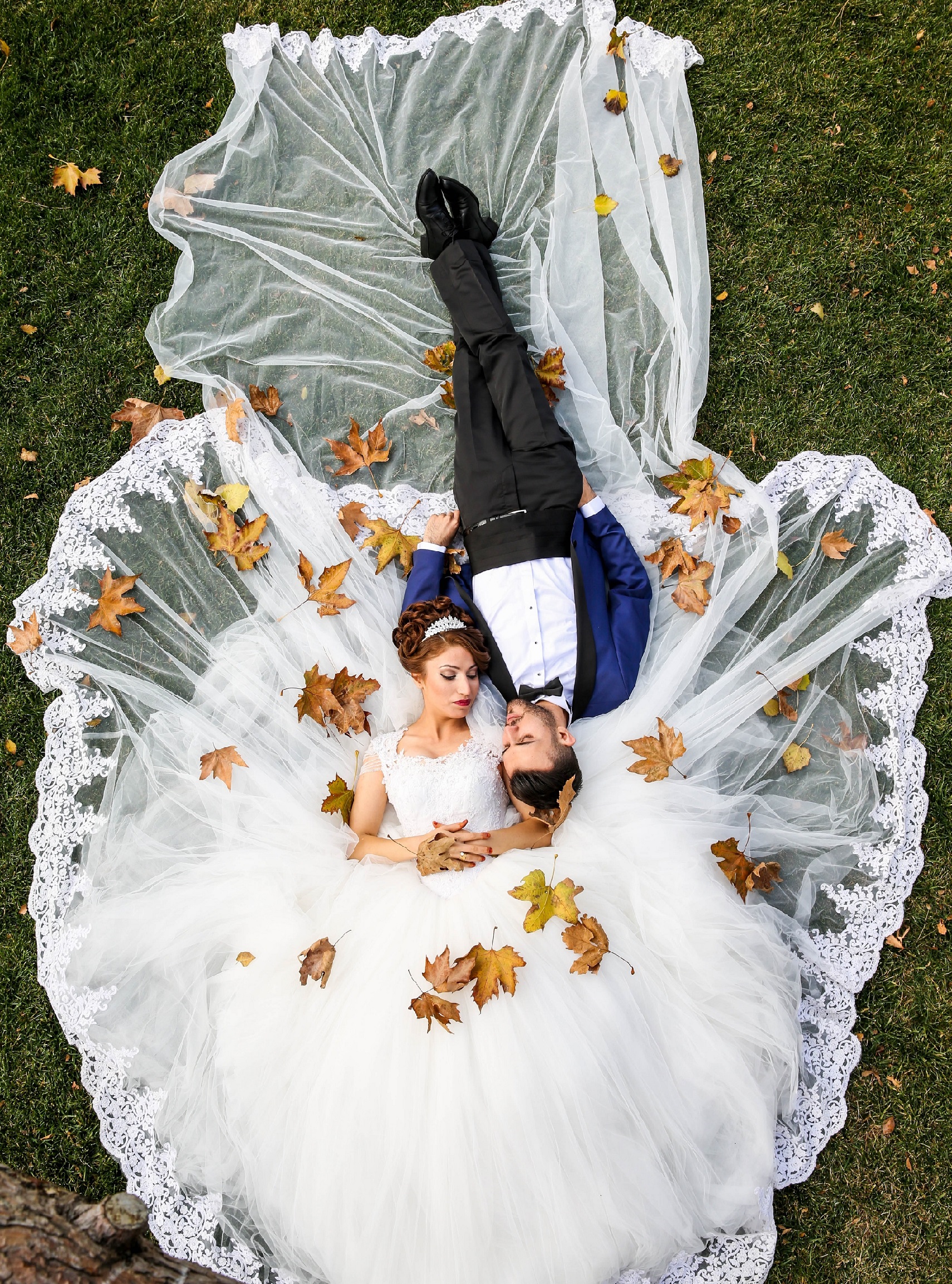 fall wedding colors - bride and groom with fall leaves