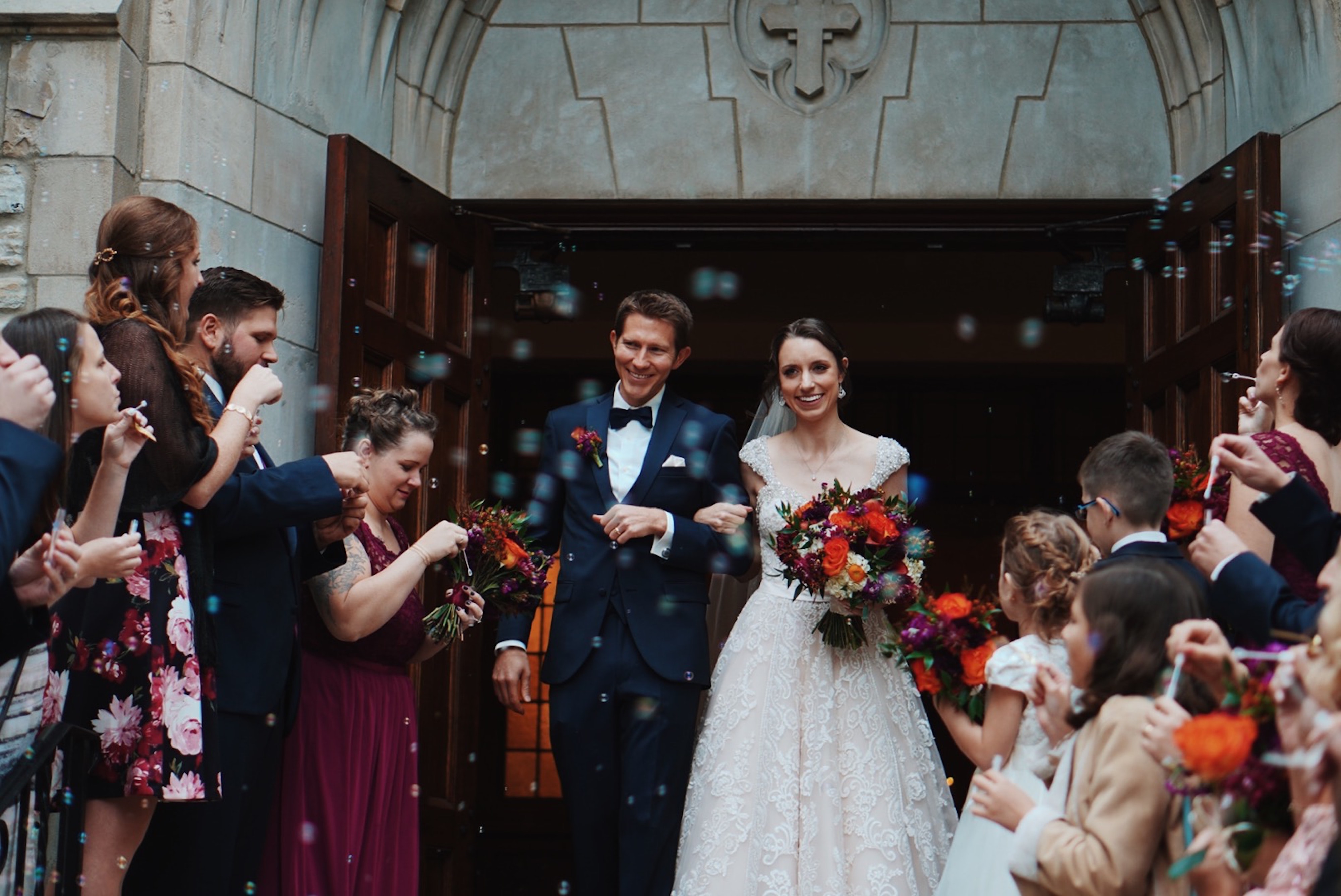 best wedding dates - bride and groom leaving church surrounded by guests