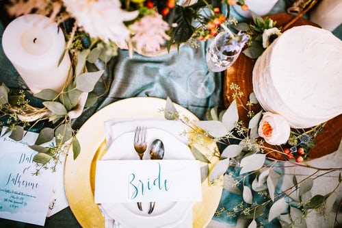 wedding table with flowers, plates, glasses