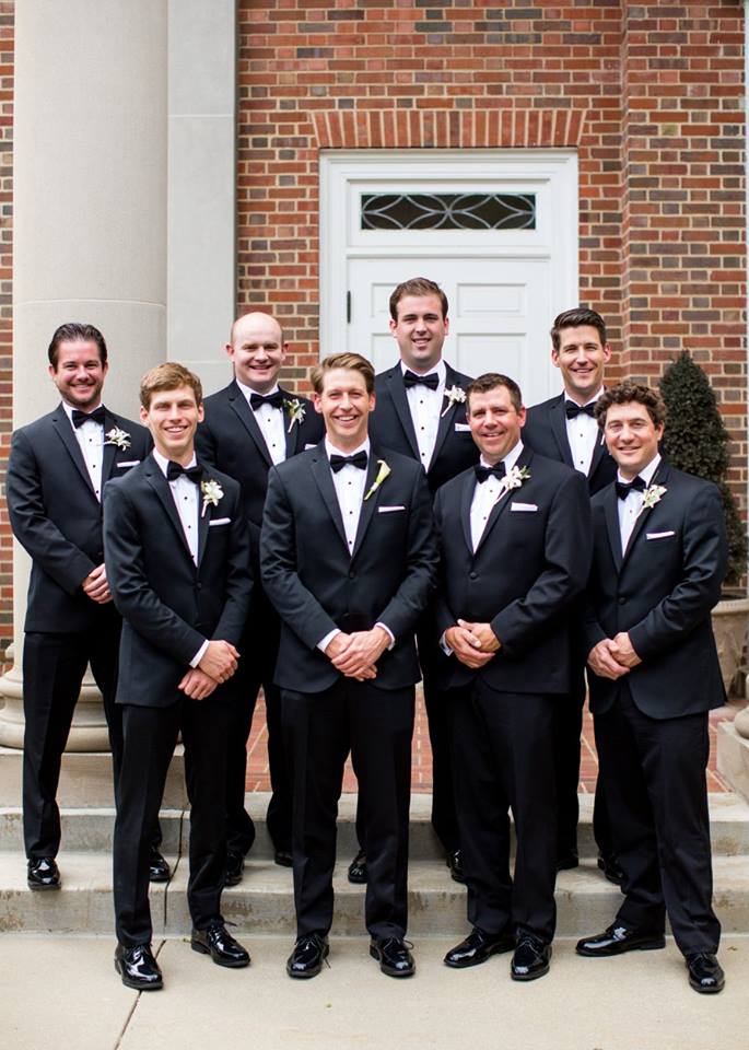 eight guys in black slim fit suits