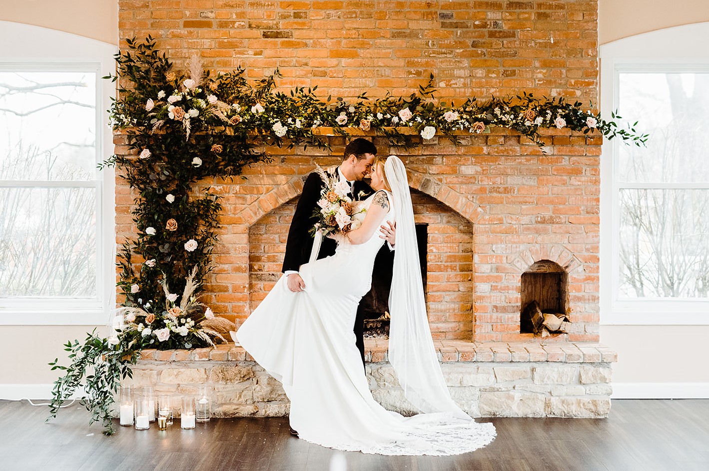 winter wedding, bride and groom seated at table near fireplace