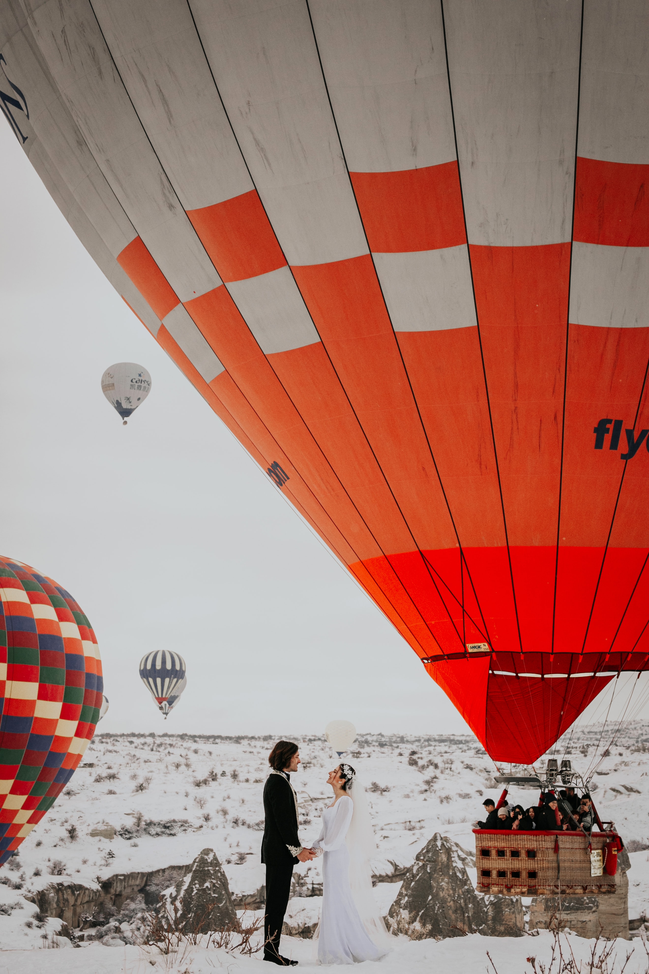 winter wedding tuxedo - bride and groom with hot air balloon in winter