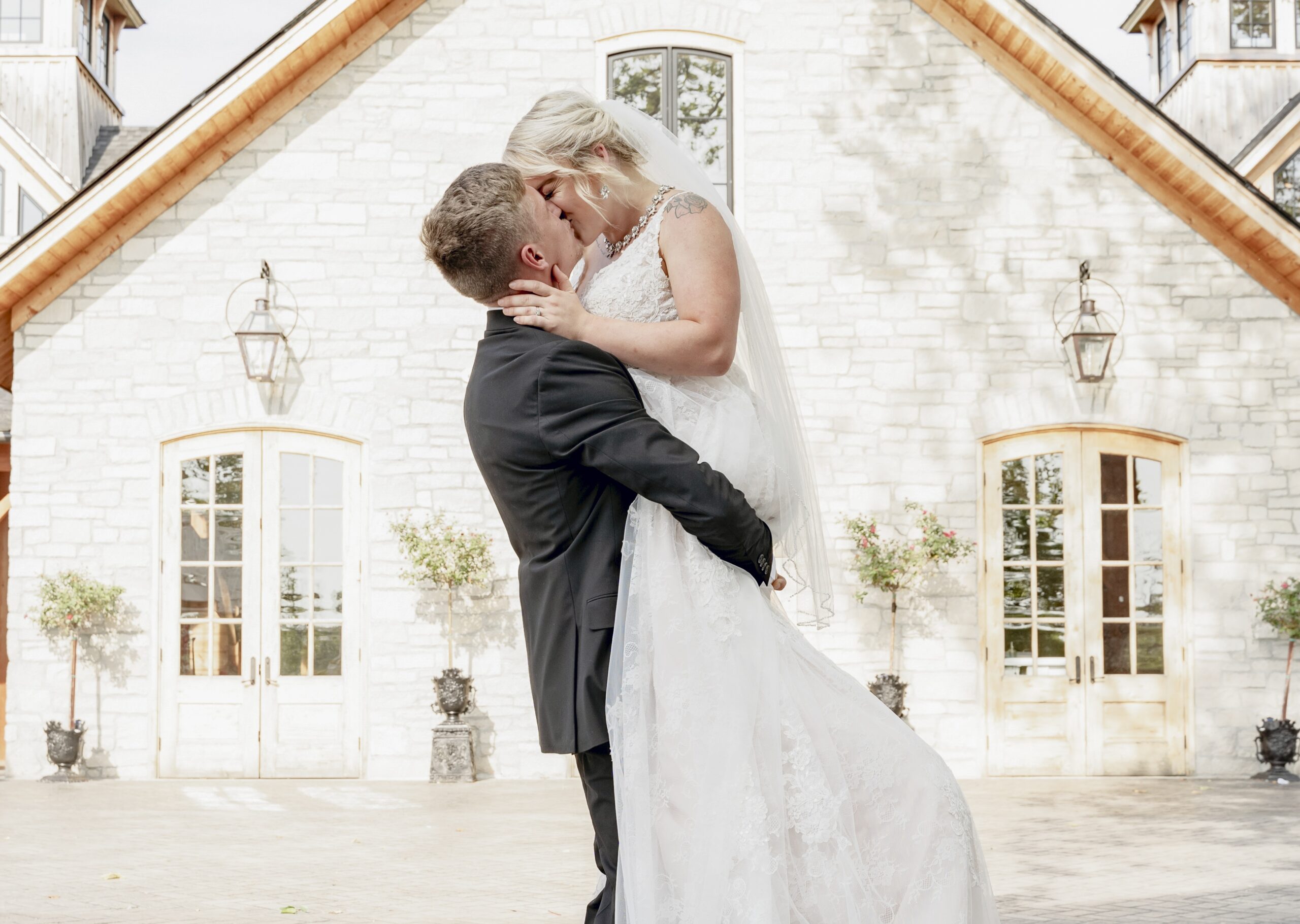 wedding insurance - bride and groom kiss in front of church