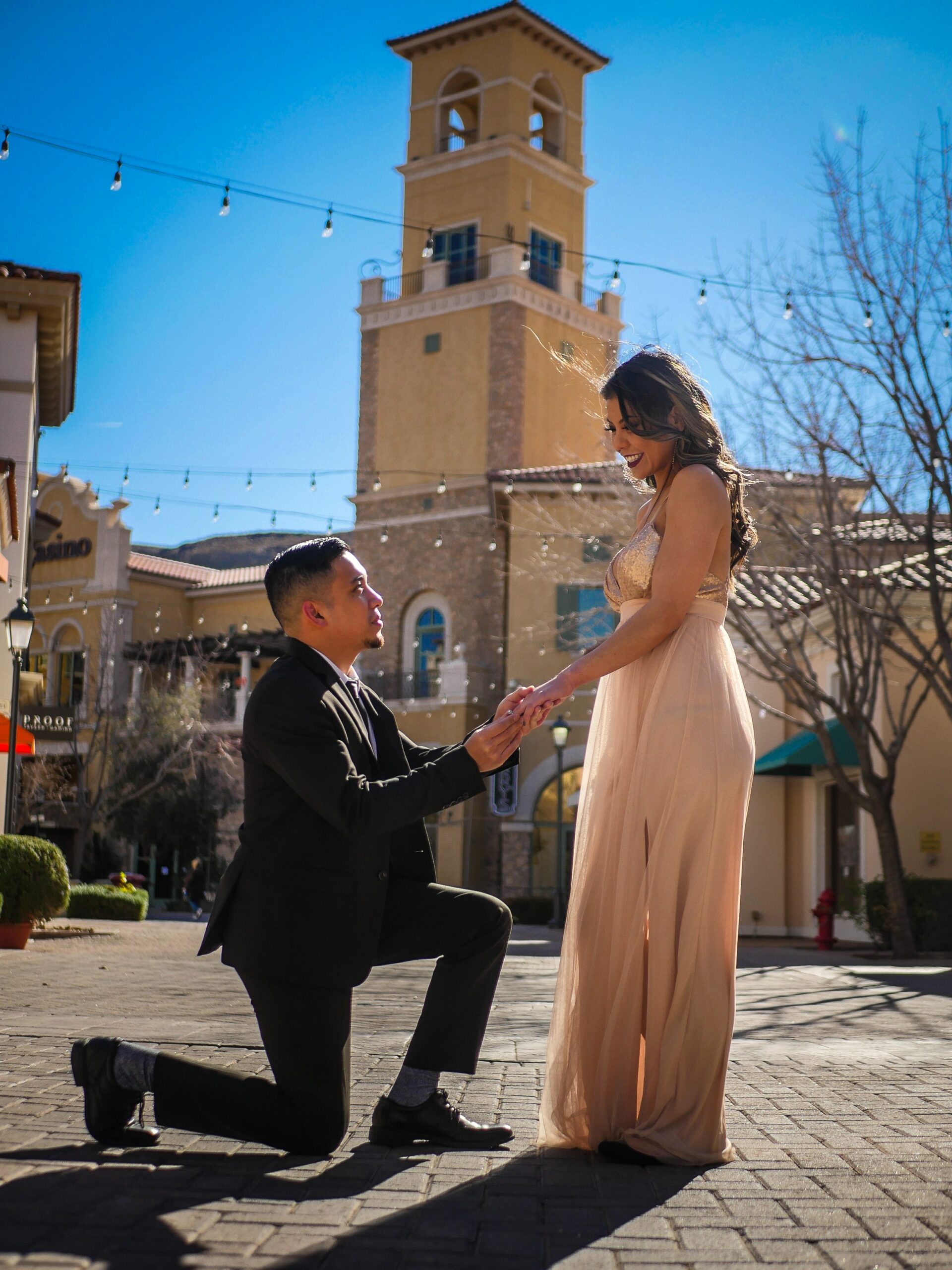 engaged couple in front of buliding