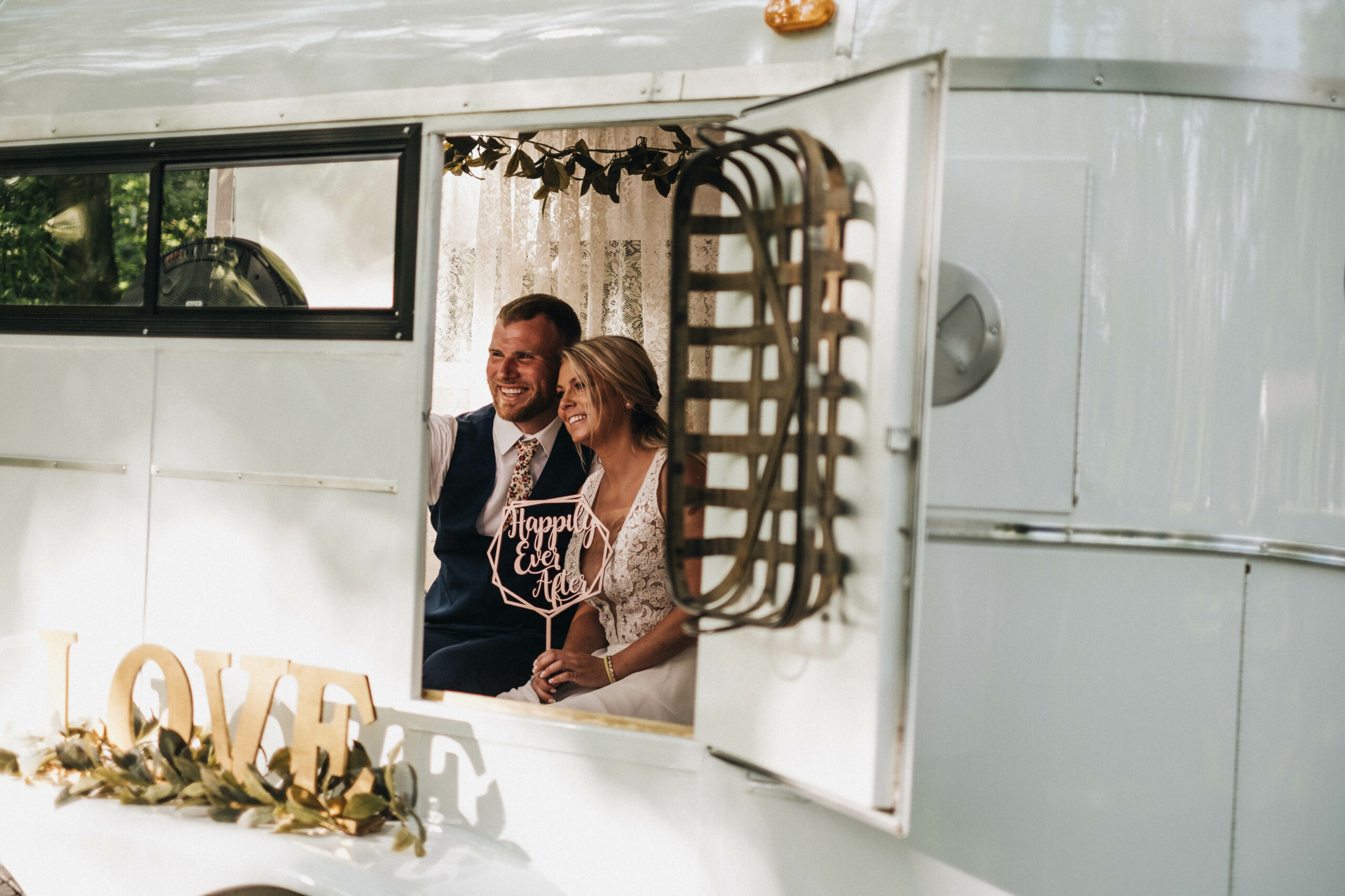when should I order my tuxedo rental - bride and groom in photo booth