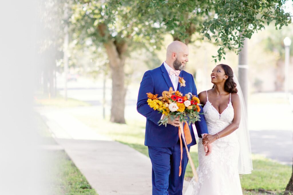 when should I rent a tuxedo - bride and groom walking on path