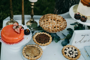 Table filled with baked goods. Trending wedding bar ideas.