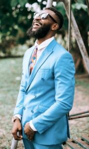 black nam in cornflower blue suit and bold patterned tie