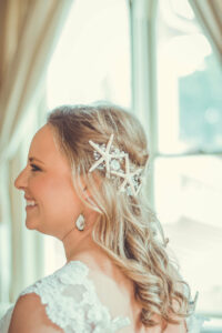 bride with hair half pulled back with star fish accents