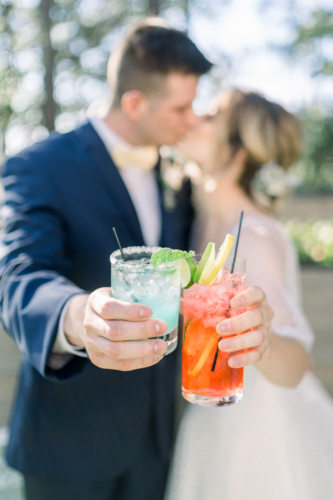 bride and groom holding signature cocktails