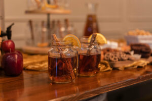 warm cider drink with cinnamon stick 