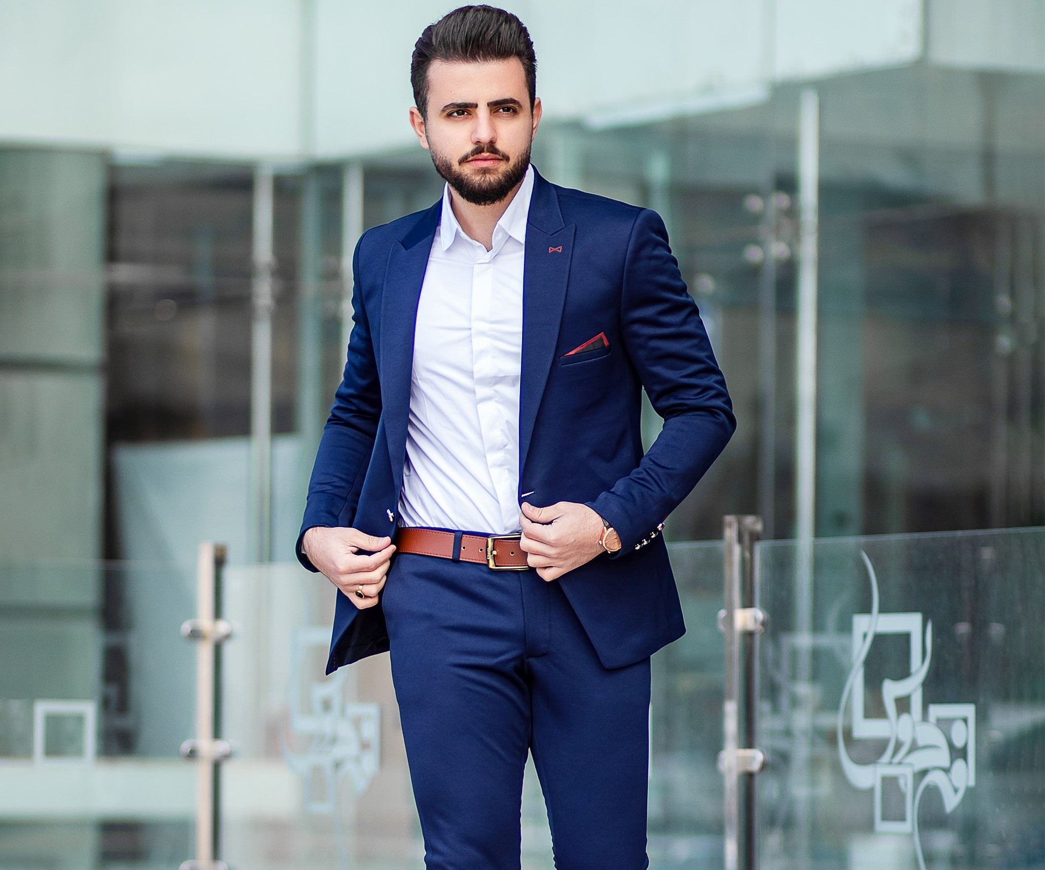 man in blue suit without a tie and brown belt