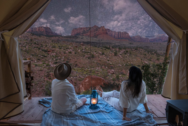 honeymoon destinations - Under Canvas where a couple view the desert 