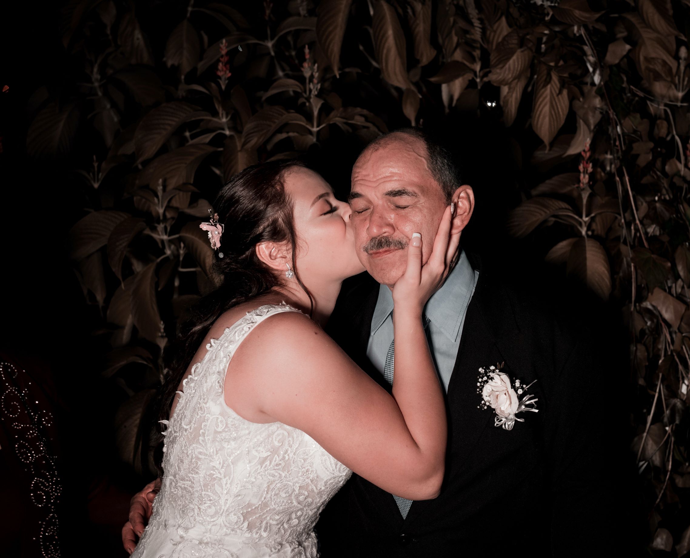 bride kissing her father on the cheek