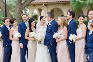bridal party with guys in blue suits, bridesmaids in pink dresses