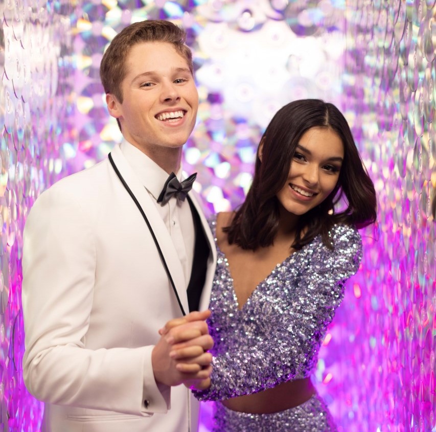 guy in white tuxedo jacket dancing with girl in lavender sequin dress