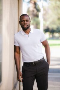 guy in white polo shirt and black pants with black belt