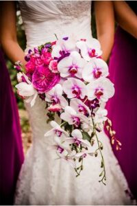 bride holding bouquet of orchids