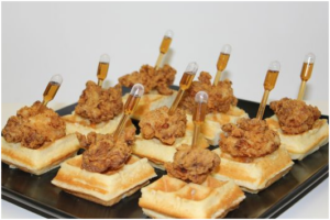 mini waffles and chicken with tube of syrup stuck in chicken