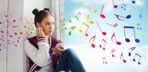 high school girl listening to music on her phone, staring out a window