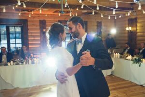 groom and bride dancing their first dance. Groom looking lovingly at bride