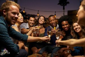 Group Of Friends Enjoying joint bachelor/bachelorette party on Rooftop Bar