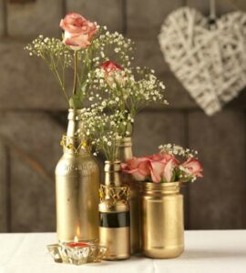 used bottles spray painted gold metallic and used for center piece on wedding table