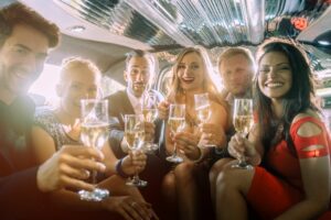 group of friends in limo, holding glasses of champagne for joint bachelor/bachelorette party