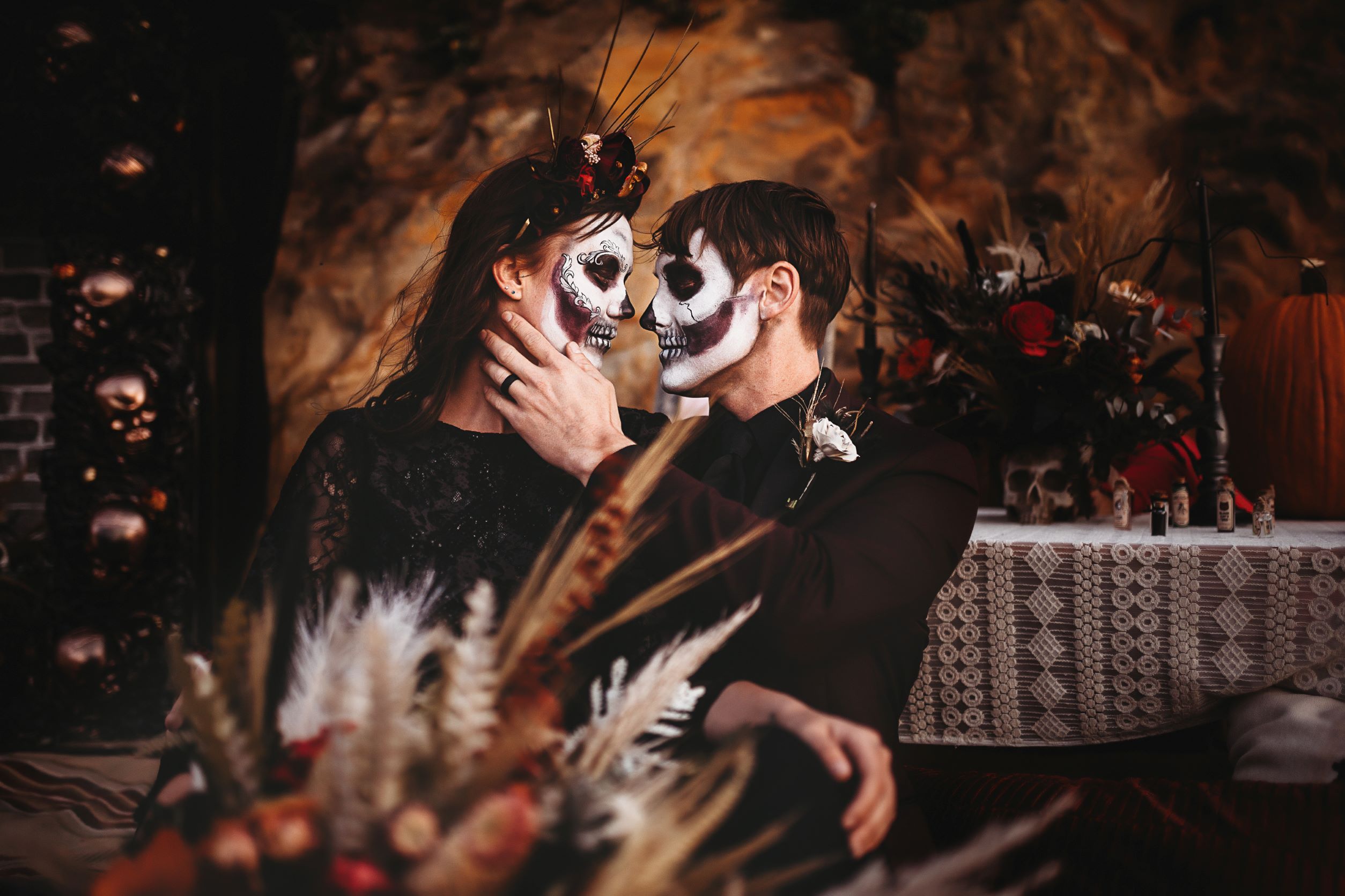 bride and groom looking at each other, Halloween theme, faces are painted like skeletons