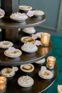 mini pies in a variety of flavors on a cake stand.
