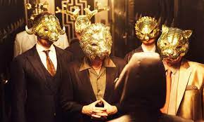 guys wearing suits with gold animal masks, from the Squid Game show
