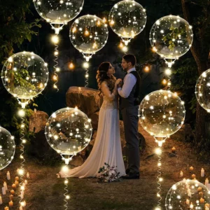 bride and groom outside, holding each other, with transparent led balloons all around them.
