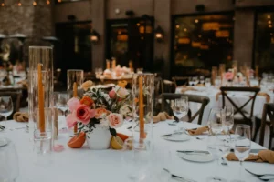 wedding table setting with tall candles in tall clear holders