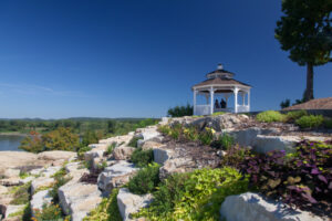 bride and groom in a gazebo on top of a hill in Herman, MO