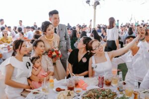 group of friends taking a selfie to share with the couple via a wedding hashtag