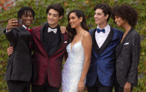 group of 3 boys and 2 girls taking a selfie in their formal homecoming attire