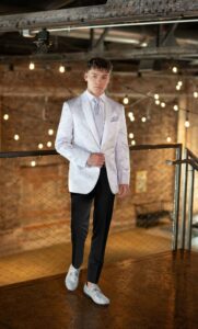 prom trends - guy in white/silver paisley jacket, black pants, and silver sparkle shoes