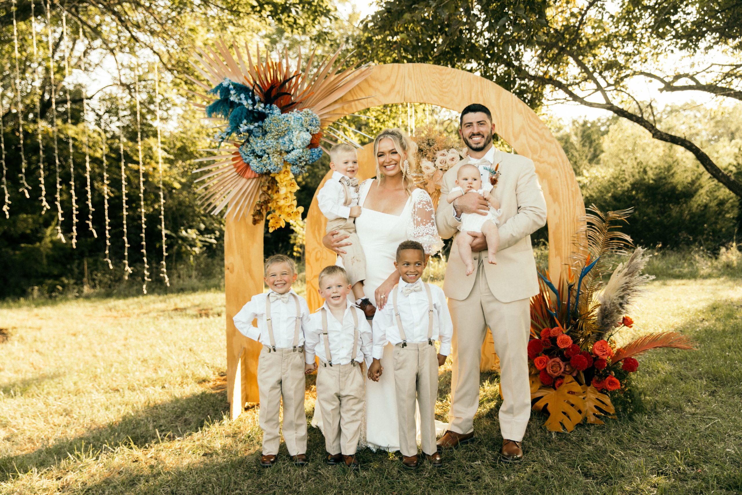Bride and groom posing with ring bearers