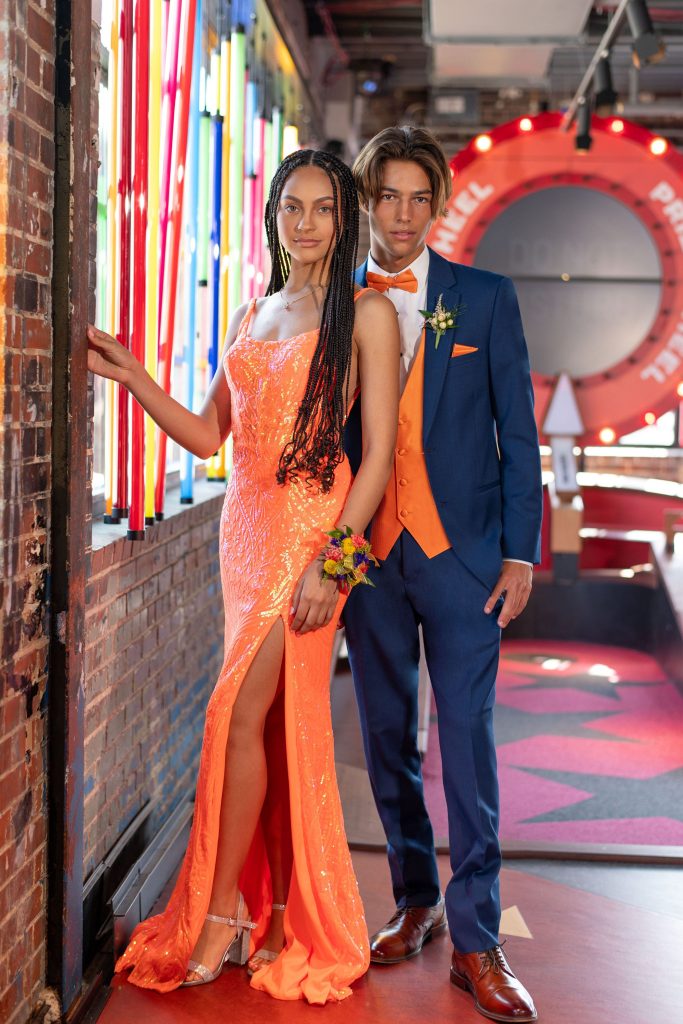 Prom couple in an orange dress and blue suit