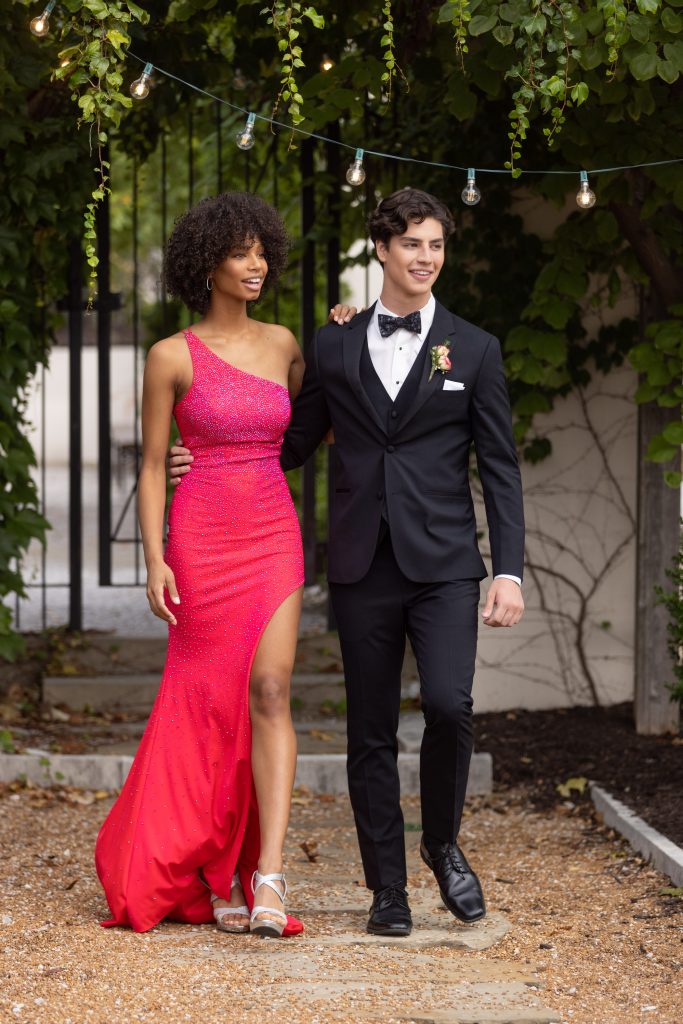 Prom couple in a red dress and black tuxedo 